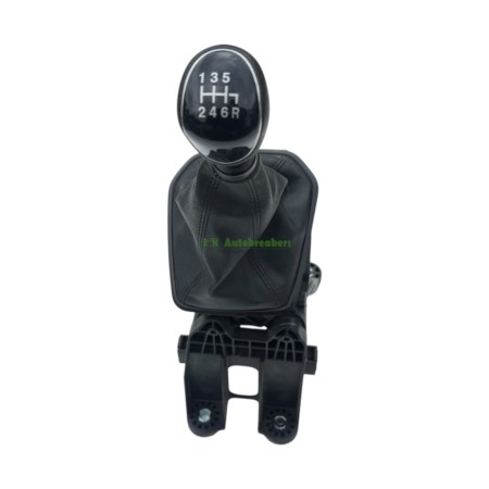 Manual gear shift knob showing 6-speed pattern with reverse (1-2-3-4-5-6, R) and black leather boot, photographed from above in a car interior.