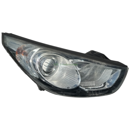 Close-up of a car headlight assembly with clear lens and reflective housing.
