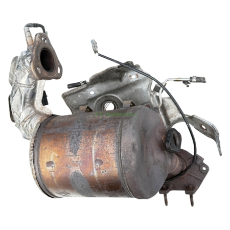 Rusty catalytic converter with heat shield and attached wiring, showing corroded metal and mounting flange