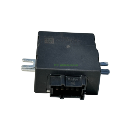 Black automotive relay module with a multi-pin connector and BMW branding visible on the side