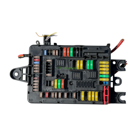 Open car fuse box with a variety of color-coded blade fuses and wiring harnesses visible