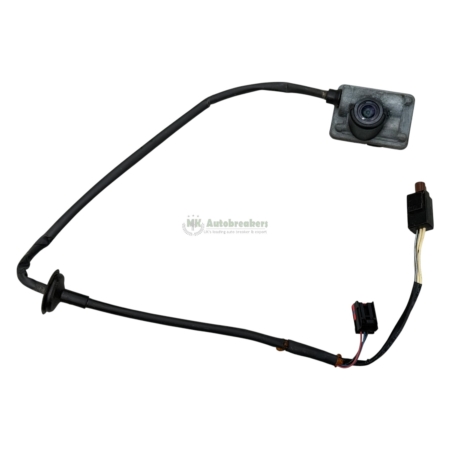 Rear-view car backup camera with a black wiring harness and connectors