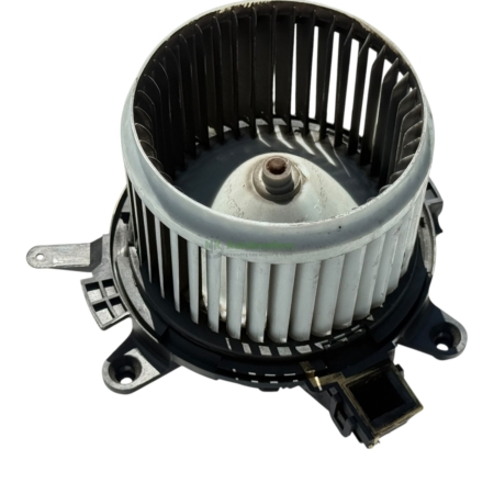 Circular automotive blower motor with plastic impeller and electrical connector (airflow fan) viewed from top.