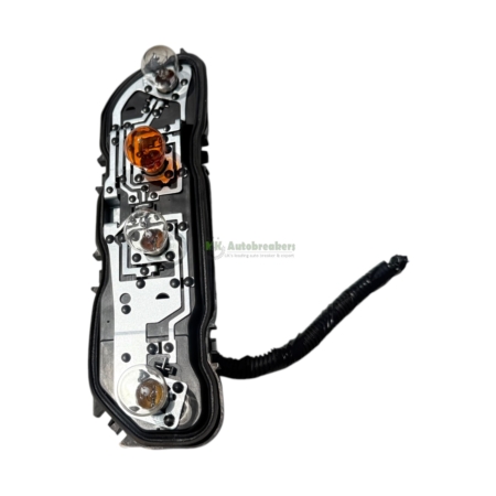 Close-up of a car tail light assembly with exposed internal circuitry and orange bulbs against a white background.