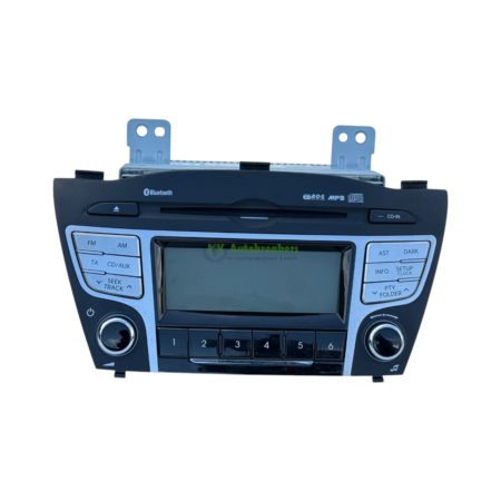 In-dash car stereo facing forward showing CD slot, touchscreen display, and labeled buttons (FM/AM, CD/AUX, Seek/Track) with Bluetooth and USB/MP3 indicators.