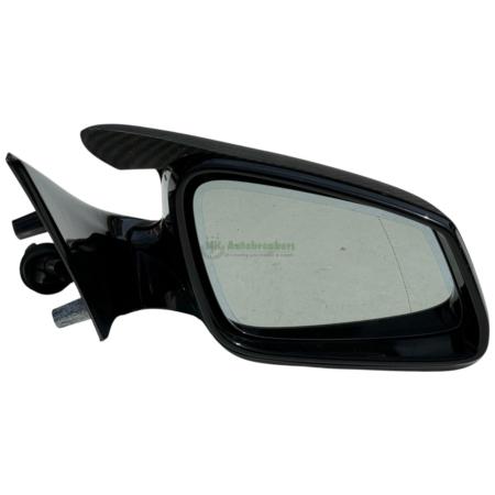 Black car side mirror with a carbon fiber spoiler on top, shown in close-up.