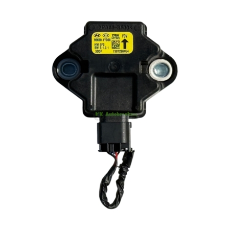 Black automotive sensor module with a yellow label and two mounting holes, attached to a wiring harness below.